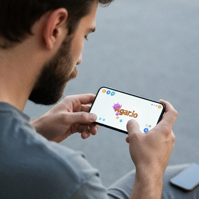 Person playing Agar.io on a mobile phone, focused, clear screen, no text, clean image